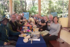 Adventure of a Lifetime Kilimanjaro Climb and Safari having a meal as a group with Get lost in America