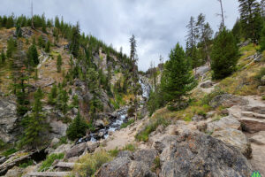 Looking back around the corner at the full length and drop of Mystic Falls in Yellowstone National Park