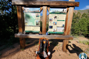 Trail Head sign, Lost Creek Wilderness information with a map, and a selfie of my backpack