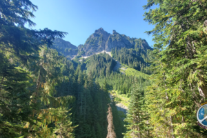 From the trail a set of peaks become more prominent as forest opens