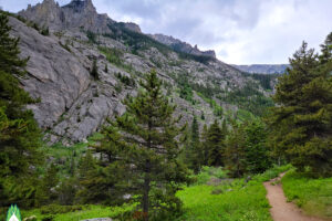 Small meadow opening with jagged peaks on three sides and open valley behind you.