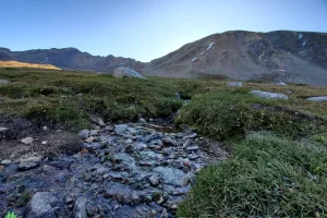 Fryingpan River can be crossed in two steps, up here below Independence Lake, there bits of ice on rocks and back eddies