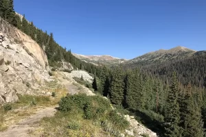 Hiking the railroad bed with rock cliffs to one side and the valley below on the other side. Get Lost in America.