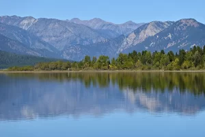 Summer reflecting mountains upon Hebgen Lake, Montana. Get Lost in America