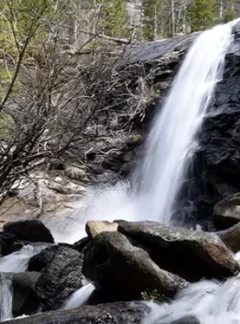 Our guide covers a hike Bridal Veil Falls, McGraw Ranch's history in Rocky Mountain National Park, and essential tips.