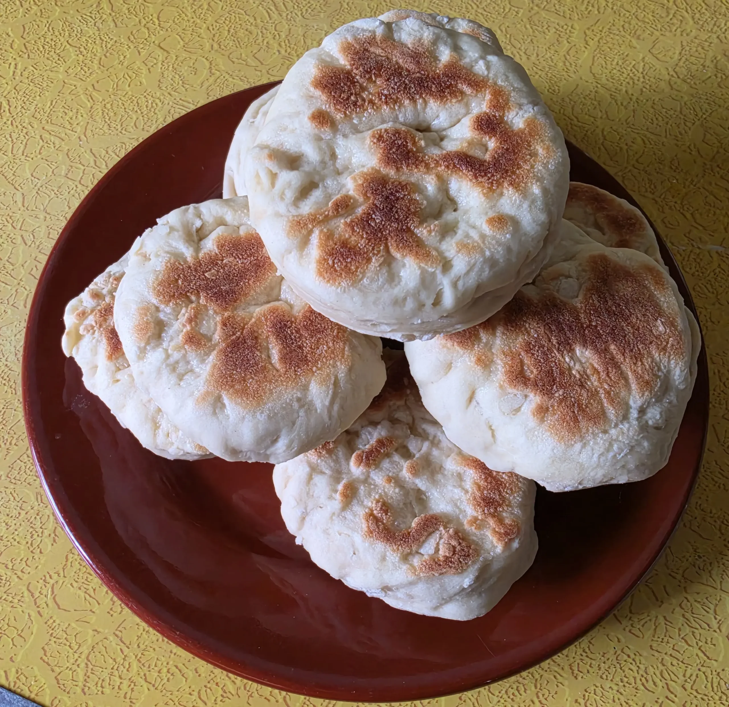 Top view of a stack of sourdough English Muffins.